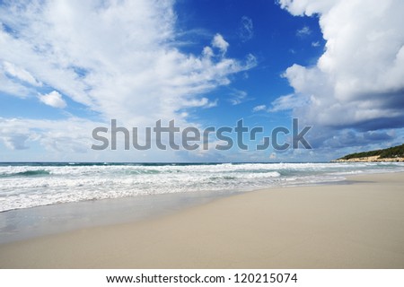 Landscape with sea and sand, white clouds in the sky