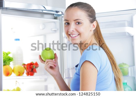 Young woman takes an apple