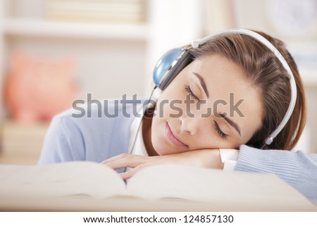 female student sleeping listening music