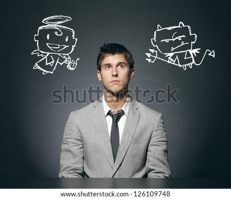Business man confused with his good and bad conscience