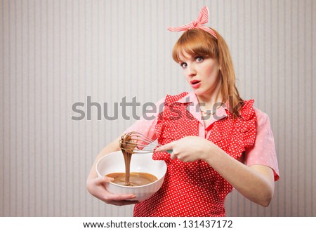 Stereotypical housewife, manual mixer and bowl, on wallpaper background