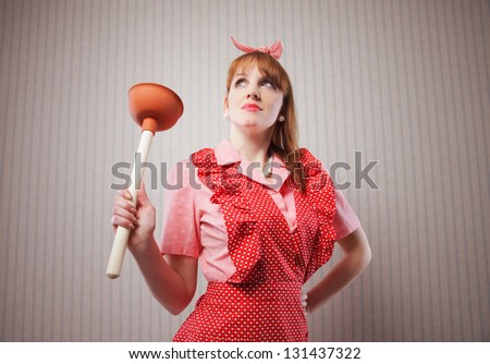 Retro housewife with tool to clean toilette