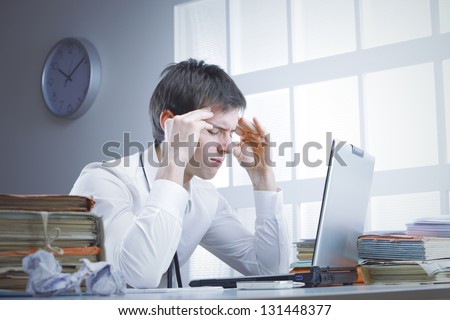 A businessman at work is stressed