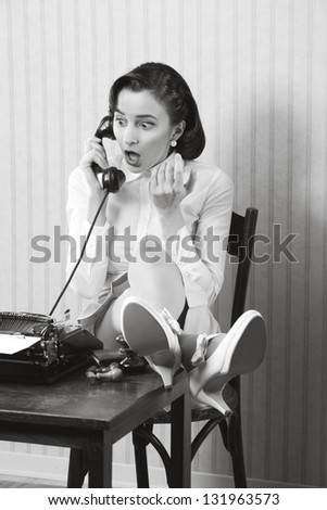 Woman talking on phone with surprised expression