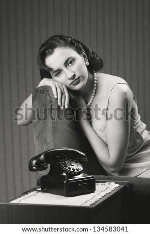 Woman wearing lingeriee waiting for the phone to ring