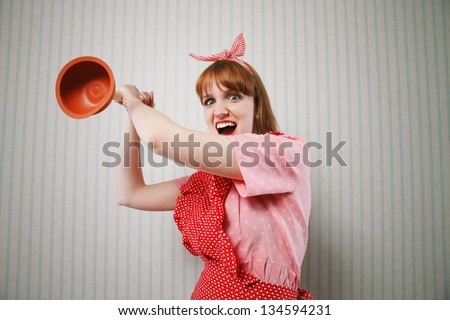 Angry housewife with tool to clean toilettes