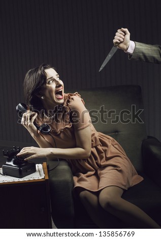 Terrified woman by a man murderess with a knife