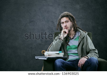 Portrait of young man student with books