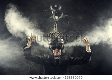 Man wearing a brain-control helmet, celebrating with open arms