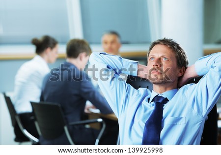 Portrait of a relaxed Businessman with meeting in the background