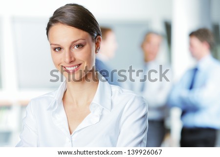 Happy Businesswoman With Colleagues In The Background