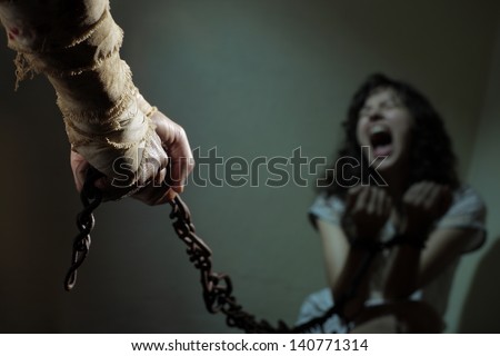 Chained slave woman,  prisoner of an evil man