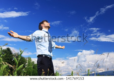 Young business man enjoying the fresh air on a sunny day