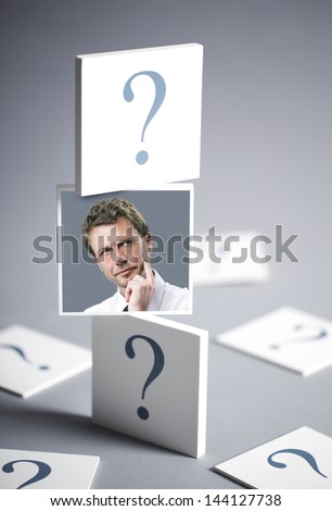 Portrait of a confused businessman surrounded by question marks