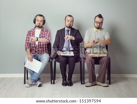 Conceptual Image Of Three Men Waiting For An Interview