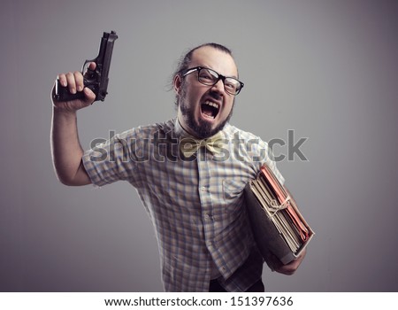 Office worker shouting with a gun on grey background