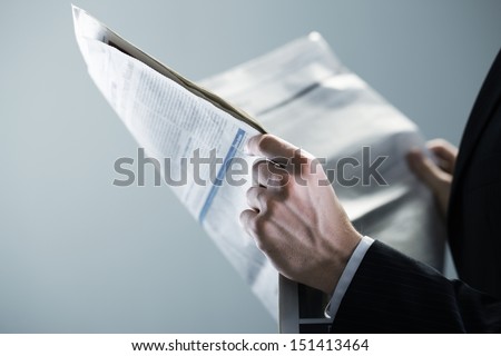 Businessman Reading A Newspaper, Hand Close Up