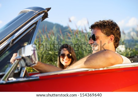 Beautiful Couple Enjoying In A Convertible Car Ride