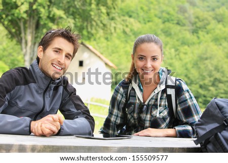 Portrait of happy hikers couple resting outdoors