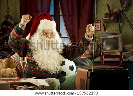 Santa Claus Watching A Soccer Match On Tv