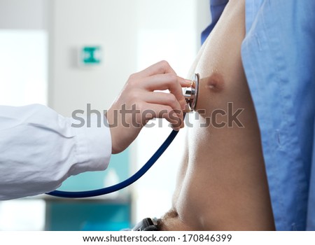 Doctor is listening to the heart of the patient