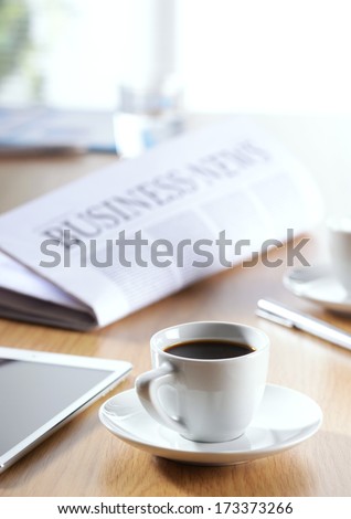 Business Office scene, digital tablet and newspaper with coffee