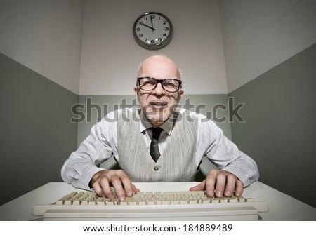 Vintage office worker typing on a computer keyboard.
