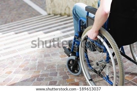 Wheelchair user in front of staircase Barrier