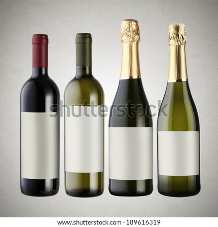 Set of wine bottles on gray background with blank labels.
