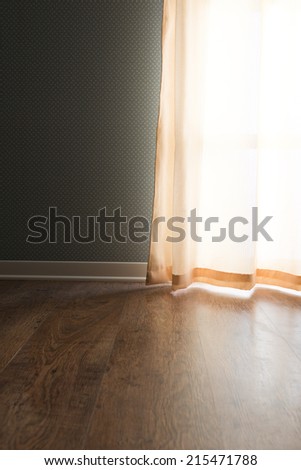 Elegant vintage interior with hardwood floor, window with curtain and dotted wallpaper.