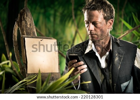Businessman lost in jungle with mobile phone and empty sign.
