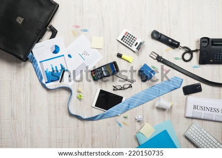 Businessman briefcase with paperwork and accessories on the floor, business failure concept.