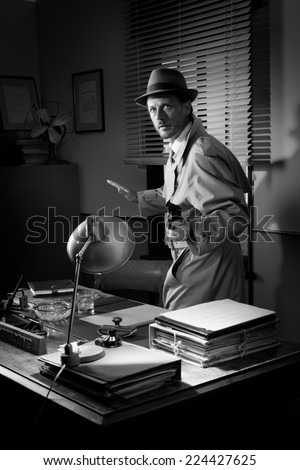 Attractive detective pointing a gun next to a desk, 1950s style office.