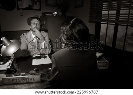 Handsome detective at office desk interviewing a young woman, 1950s film noir style.