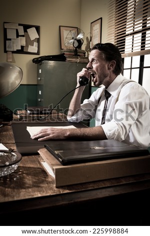 Angry businessman on the phone shouting out loud, 1950s vintage office.