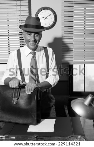 Smiling vintage businessman arriving at office with briefcase.