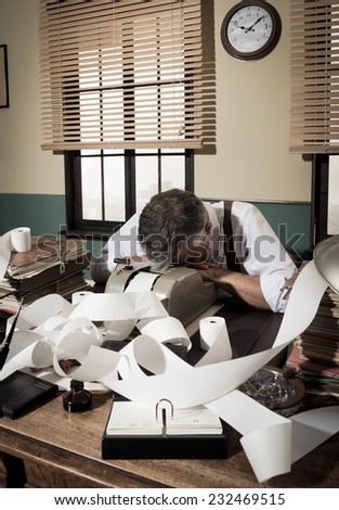 Tired overworked accountant sleeping on his messy desk, 1950s style office.
