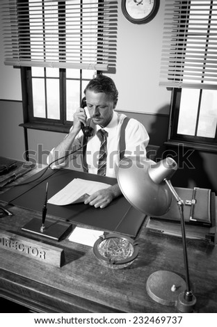 1950s office: confident director on the phone working at desk.