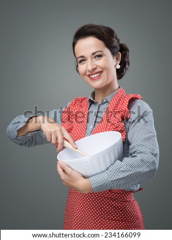 Female vintage cook mixing ingredients in a bowl and smiling