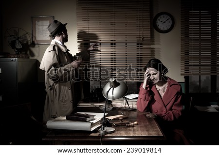 Confident detective standing in his office interviewing a young sad woman.