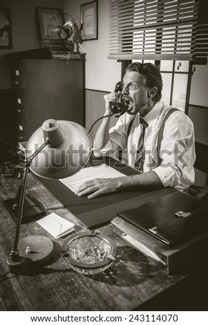 Angry businessman on the phone shouting out loud, 1950s vintage office.