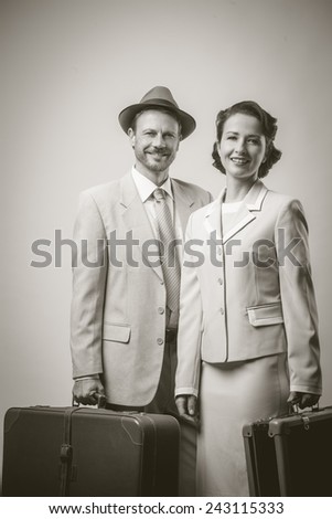 Elegant couple leaving for vacations with luggage, 1950s style