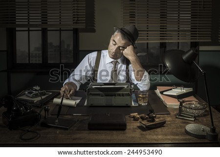 Professional reporter working late at night at his desk with vintage typewriter, 1950s style.