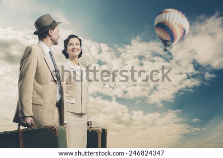 Elegant couple leaving for vacations with luggage and hot air balloon, 1950s style