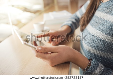 Woman using a touch screen tablet hands close up