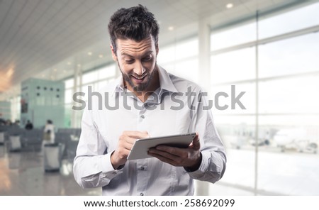 Joyful excited man receiving good news on his tablet