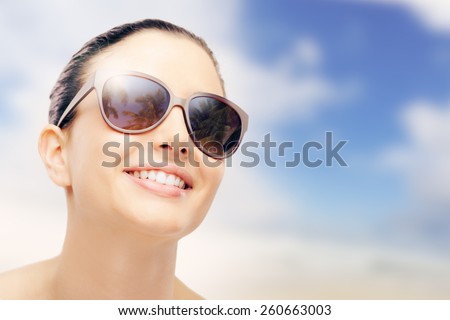 Young female fashion model smiling and wearing big sunglasses, sun protection and skincare concept