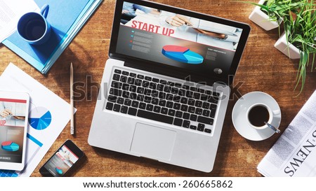 Start up website on laptop, touch screen tablet and smartphone on a desktop