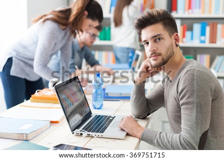 Group of college students doing homework and studying together, they are using laptops, high tech classrooms and innovation concept