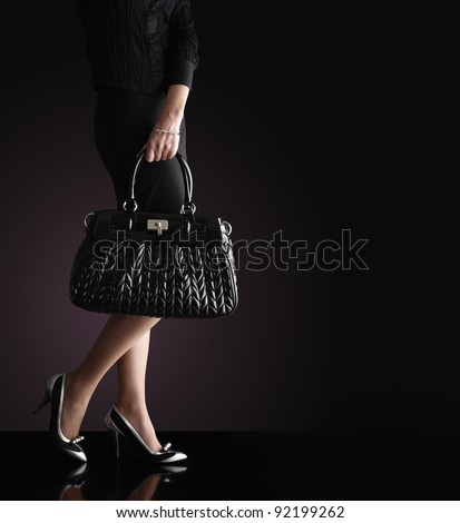 fashionable woman with a black bag, fashion photo